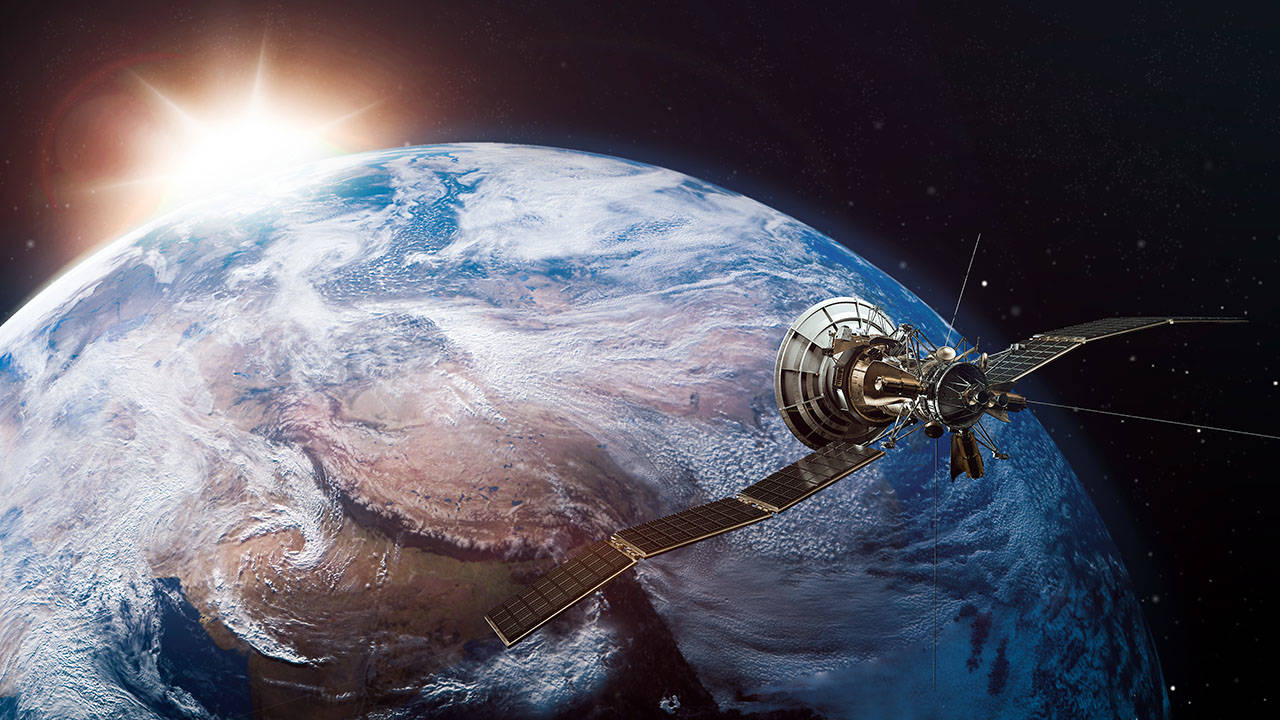 Spacecraft orbiting the earth at sunrise