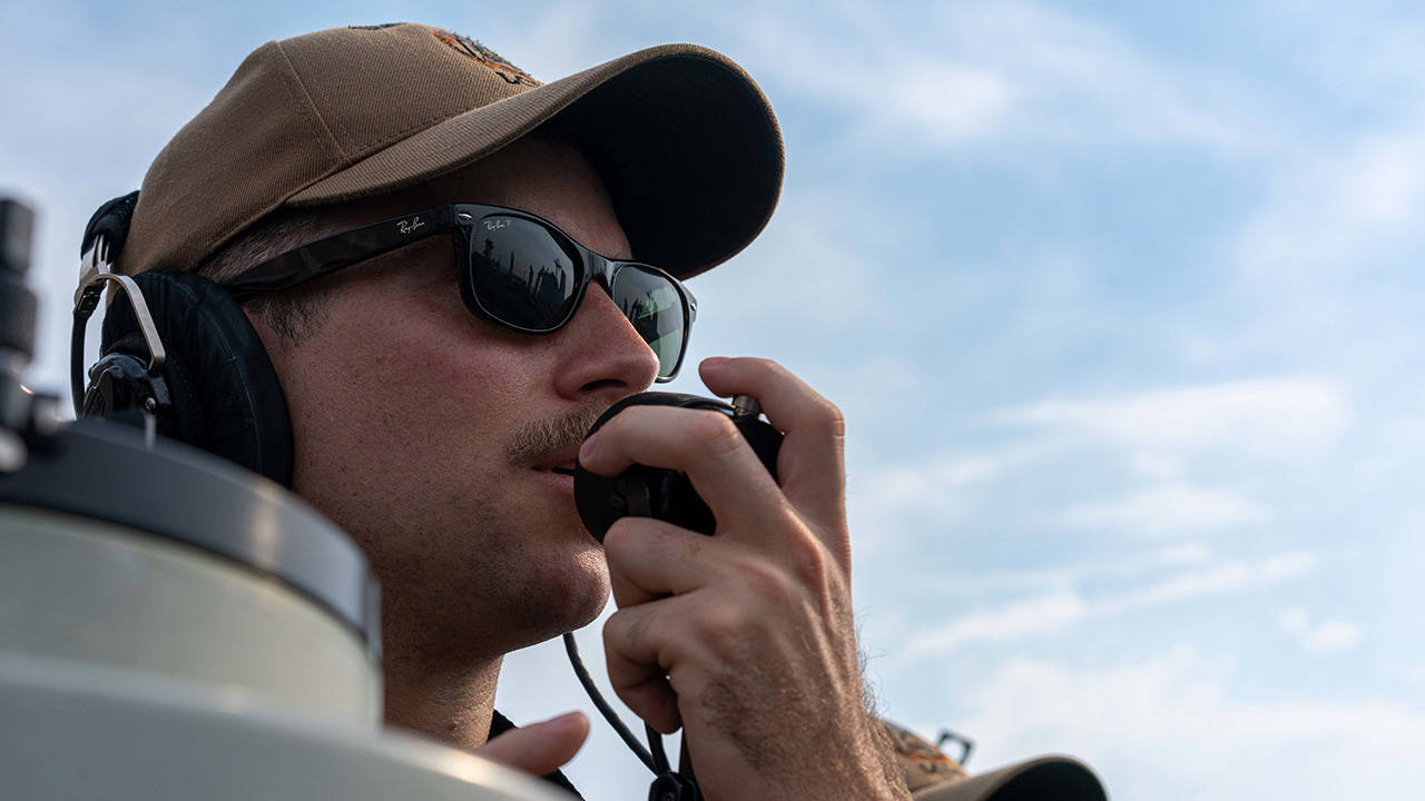 Sailor on radio onboard Littoral Combat Ship USS Jackson LCS 6